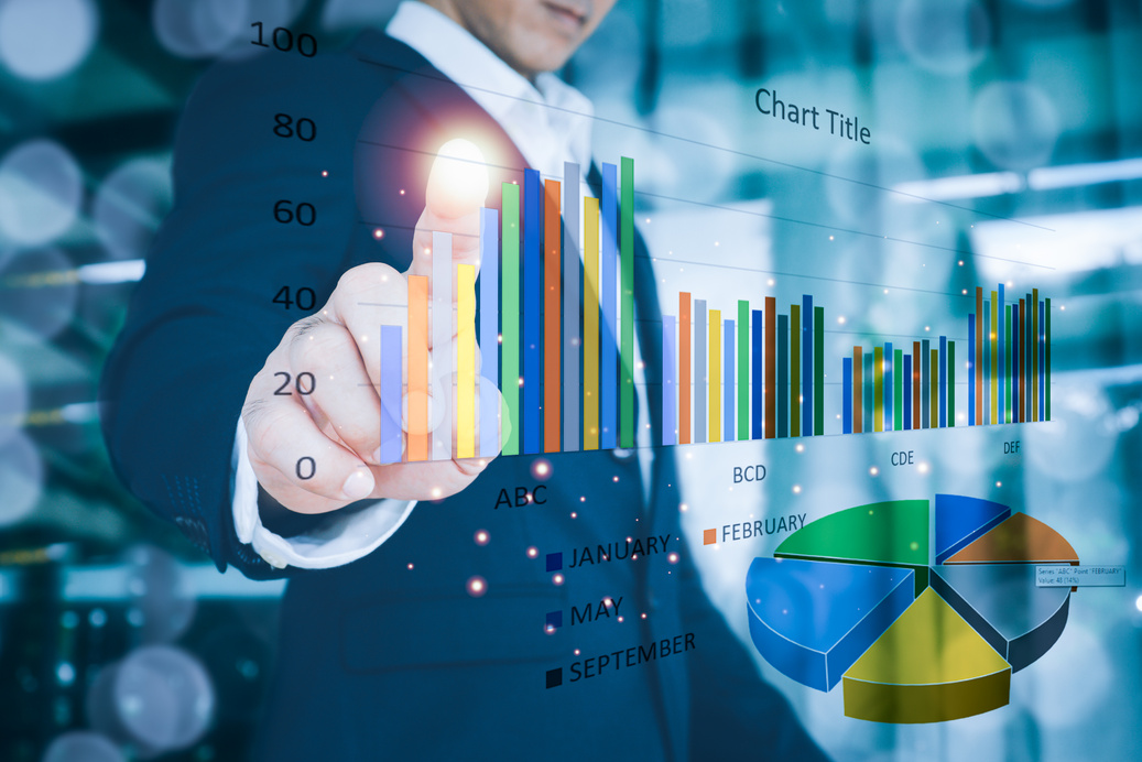 Man Wearing Suit and Pointing at Stock Chart on Screen 